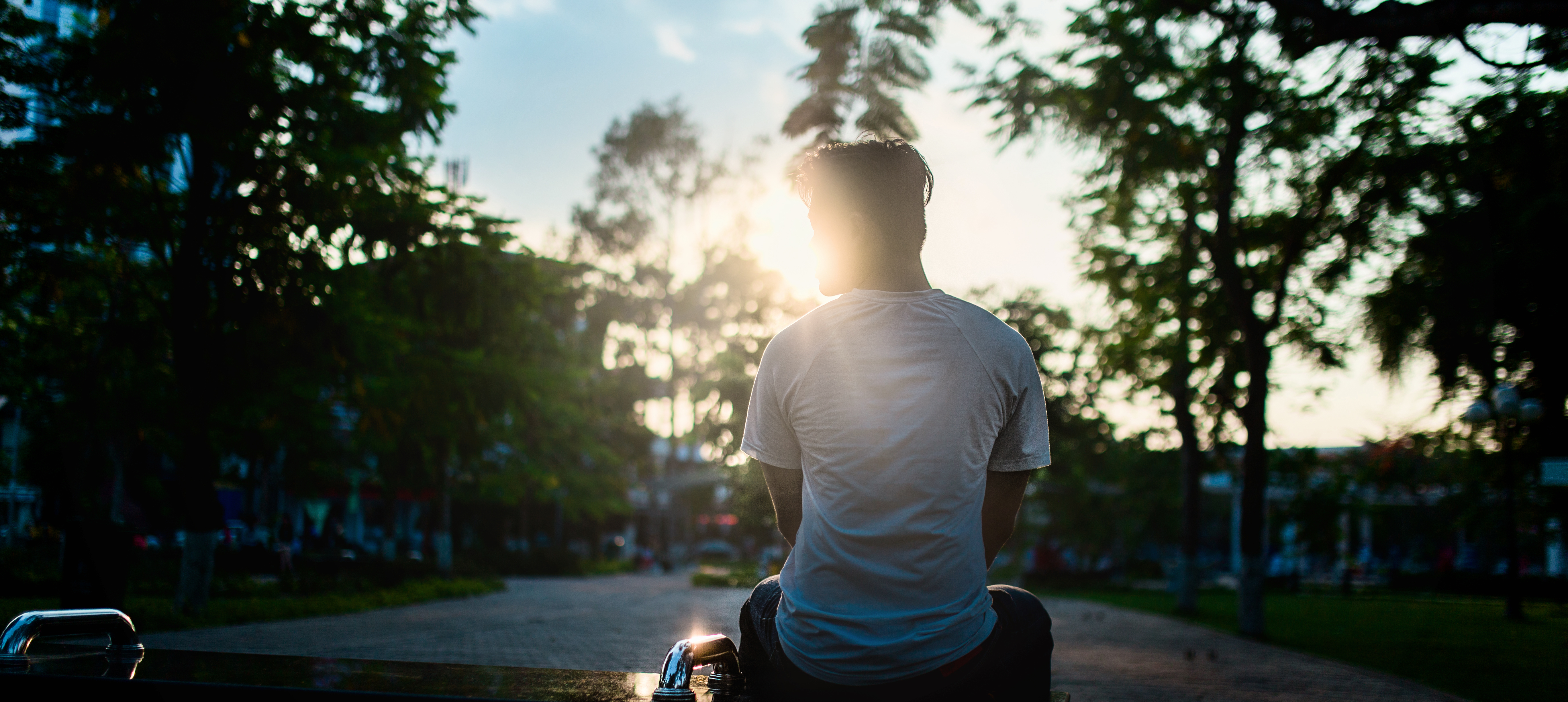 white man sitting light park