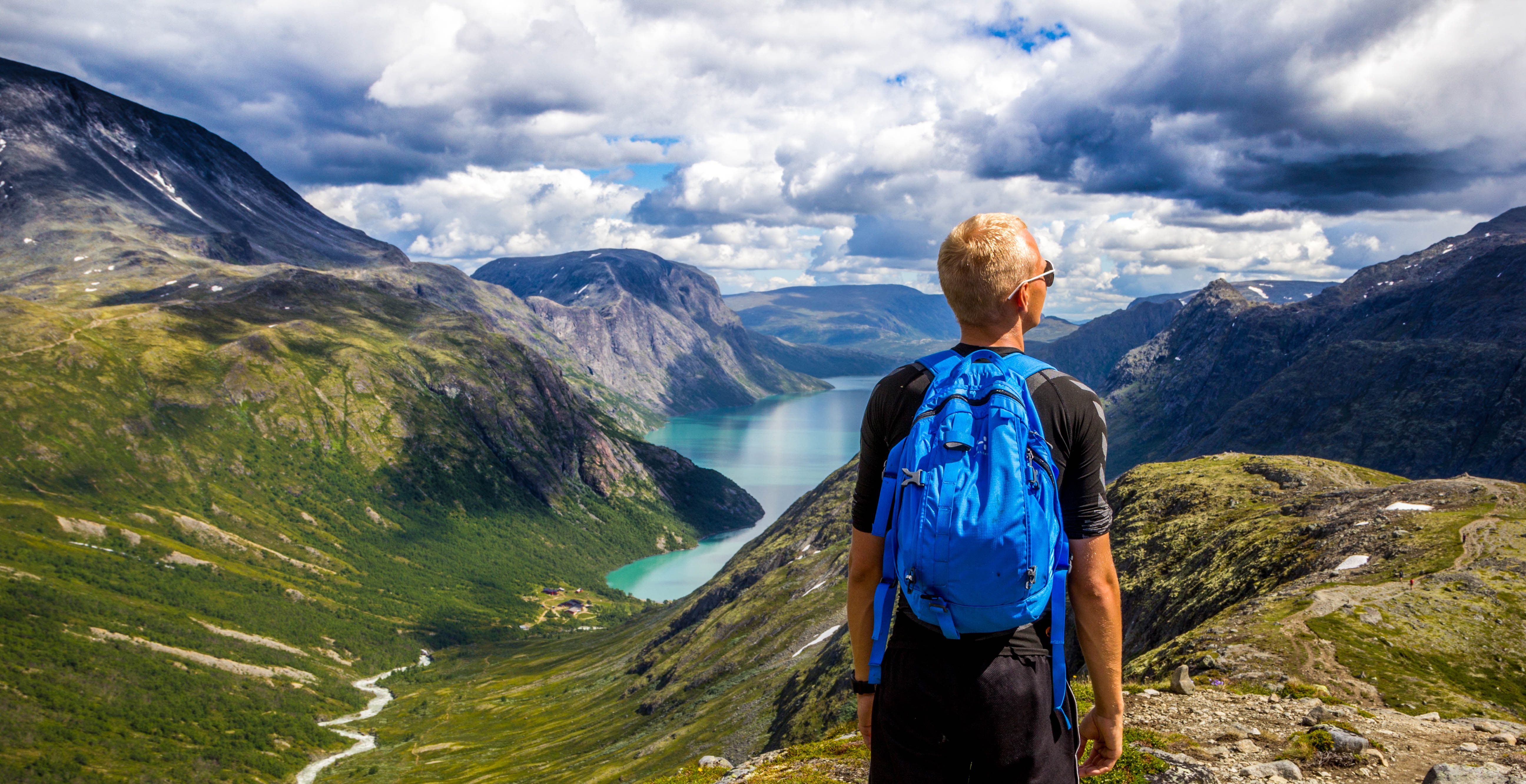 norway mountain sky blue man looking landscape