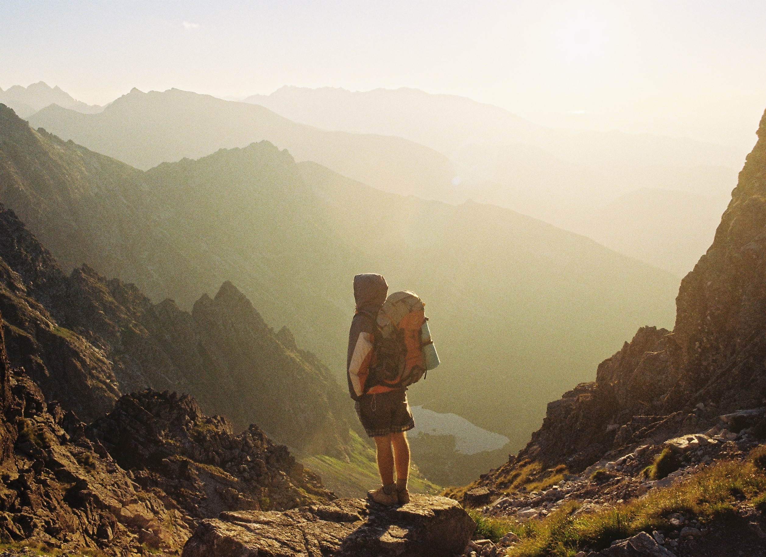 boy looking out on mountain yellow filter