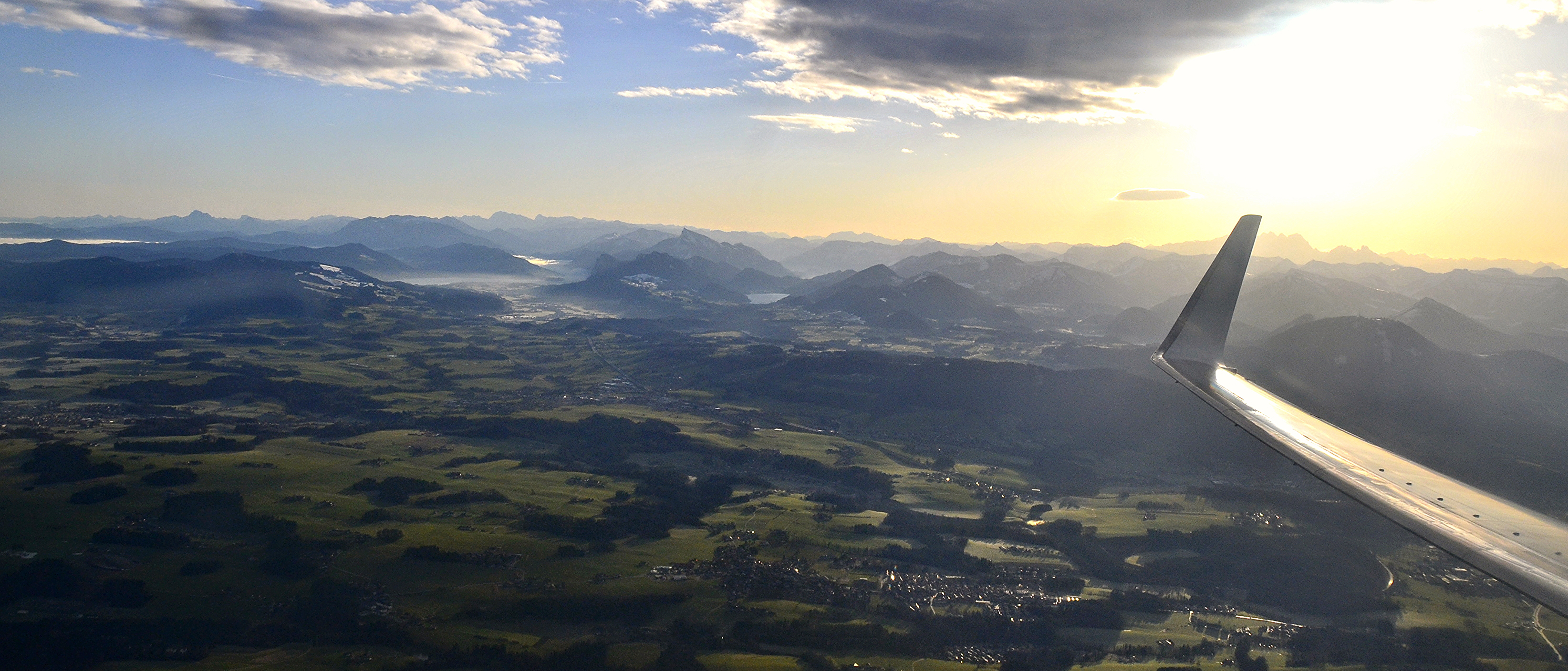 “A beautiful sunrise around 8 in the morning over the valley and mountains of Salzburg. The beginning of a quick flight to Amsterdam. I love the way the clouds and morning fog laying sleepily between the ridges while the sun illuminates and simultaneously casts shadows through a brilliant blue sky.”