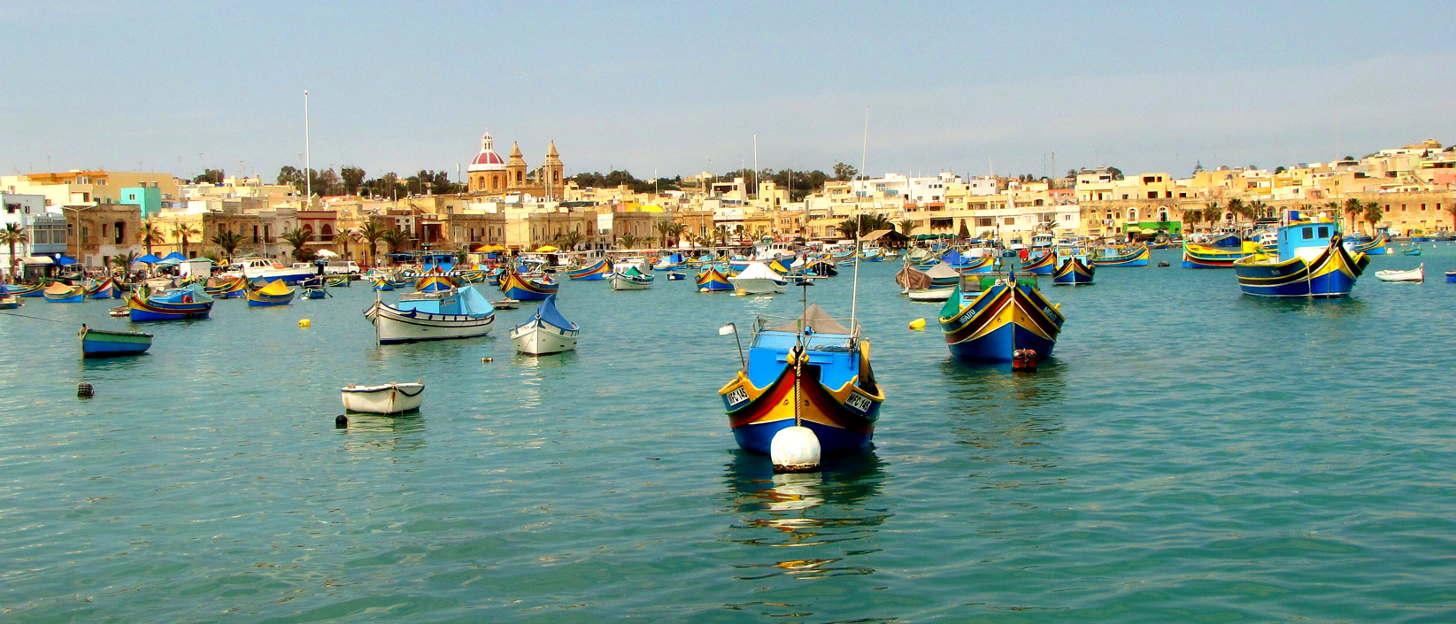 "Marsaxlokk Harbor full of traditional Maltese Dghajsa."