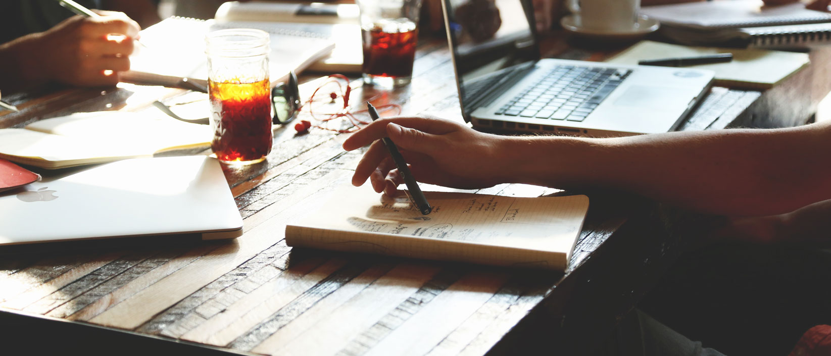 Students writing notes and drinking tea