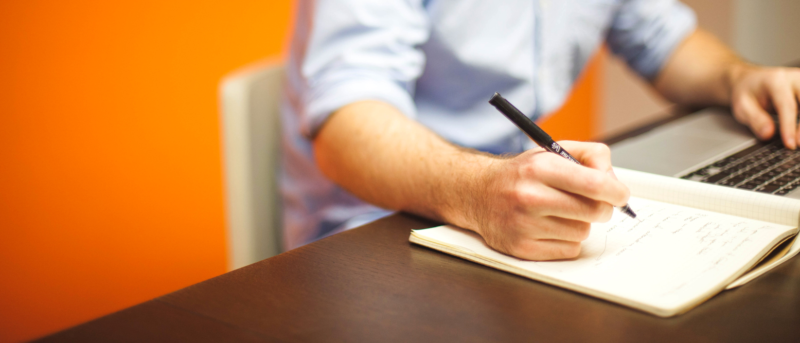 Man taking notes at desk